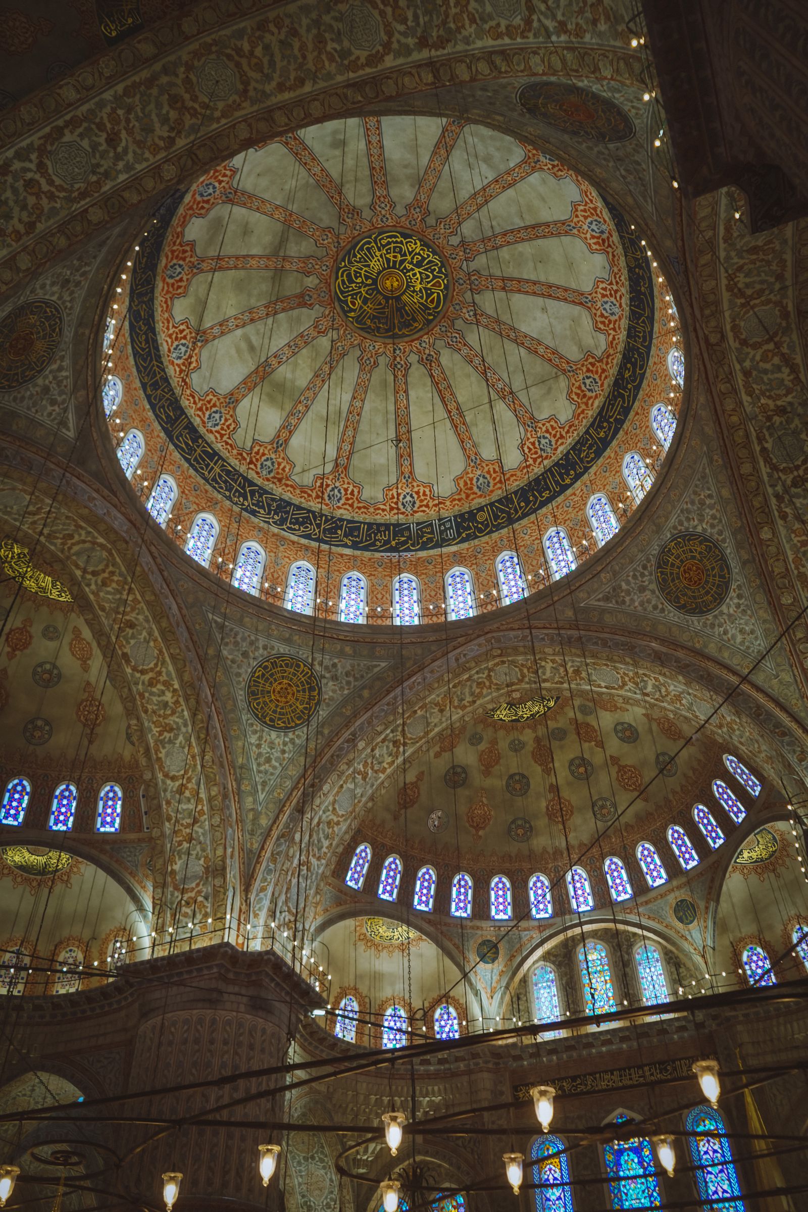 The painted domes and stained glass inside an Istanbul mosque
