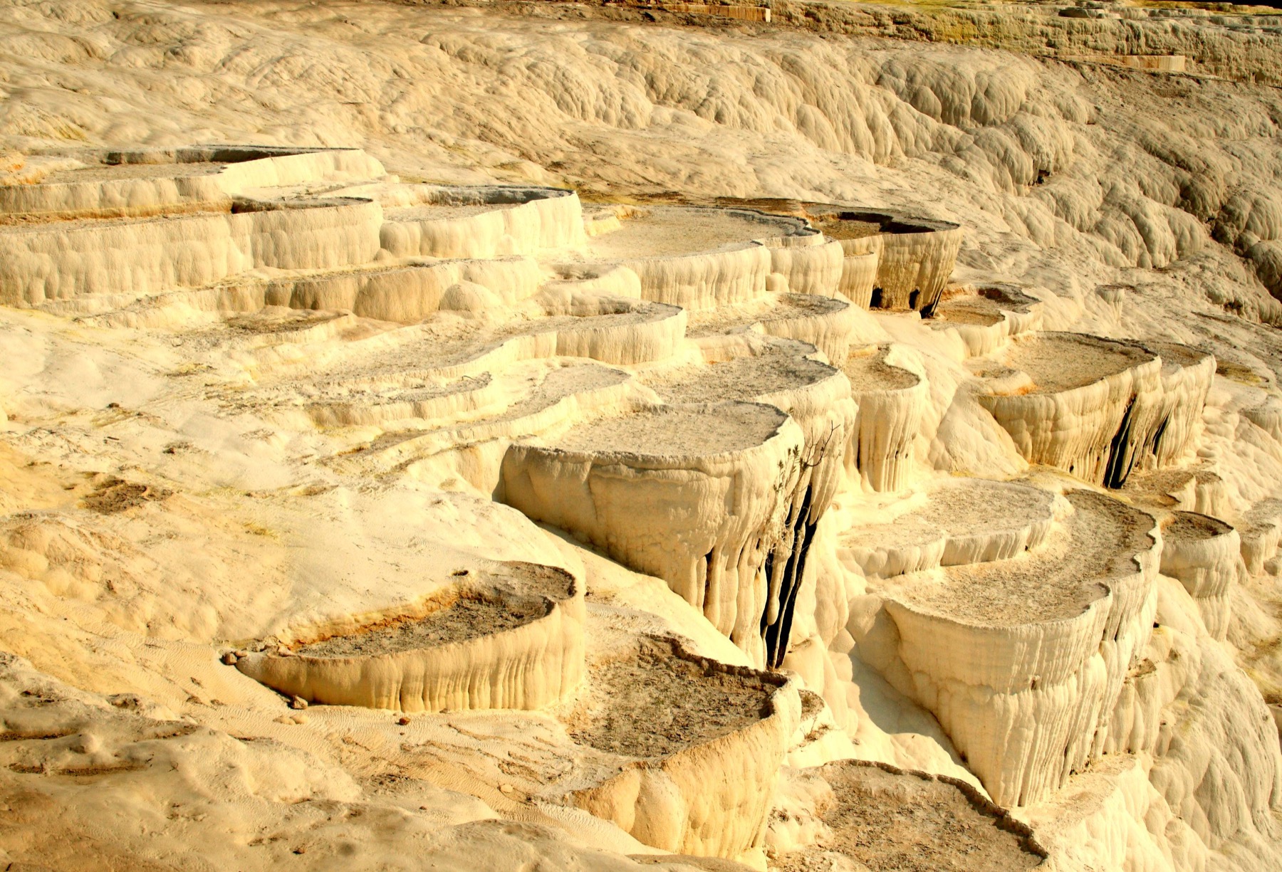 The white travertine terraces of Pamukkale in golden light